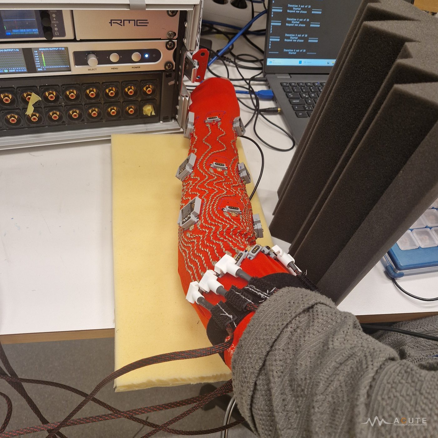 Wearable vibrotactile sleeve with conductive threads and nine actuators.