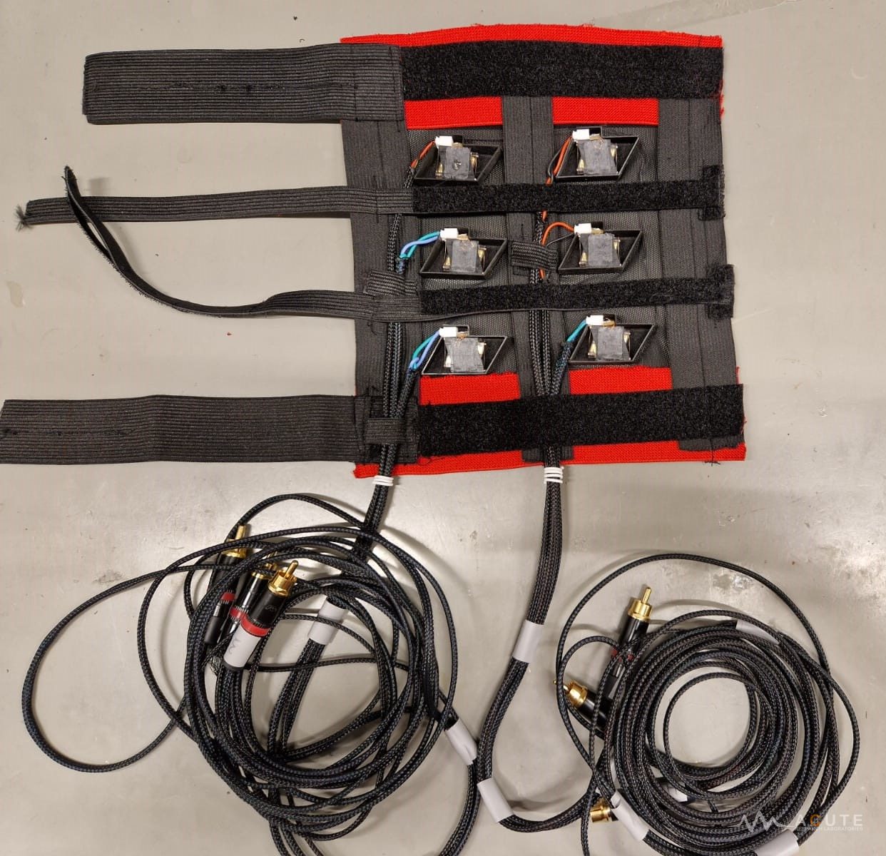 Prototype wearable vibrotactile sleeve featuring six actuators arranged in a 3 × 2 array.
