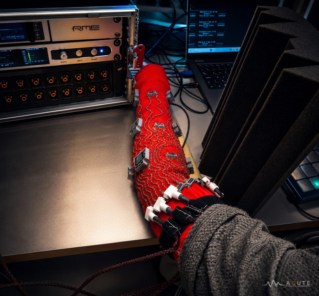 Wearable vibrotactile sleeve with conductive threads and nine actuators.